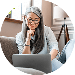 lady-sitting-on-couch-looking-at-laptop