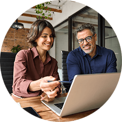 two-coworkers-looking-at-workflow-on-laptop