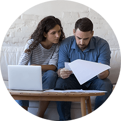 couple-looking-at-loan-papers-and-laptop