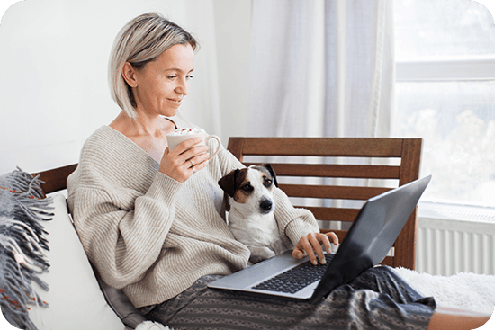 lady-looking-at-laptop-with-dog-in-lap