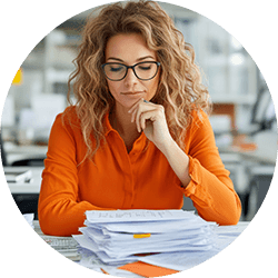 woman-looking-at-stack-of-papers