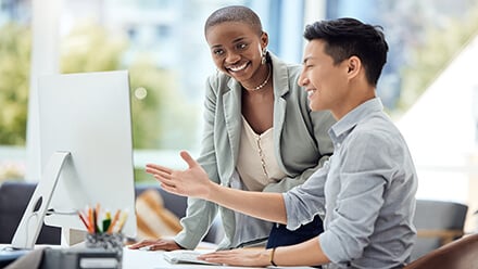 coworkers looking at CLARIFIRE on computer monitor